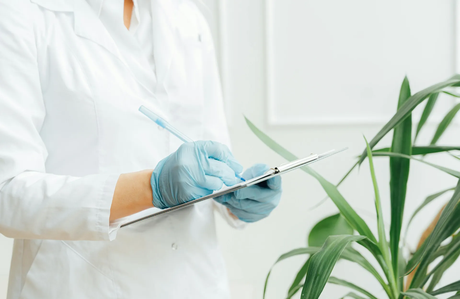 closeup on a medical professional takin notes inside medical office