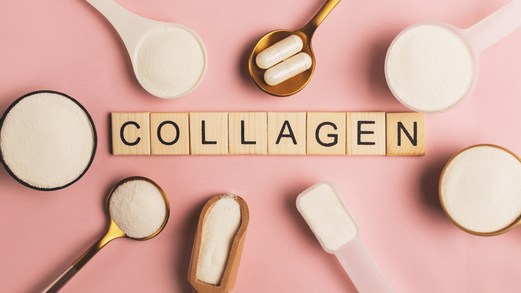 Various forms of collagen supplements including powders, capsules, and scoops arranged around wooden tiles spelling "COLLAGEN" on a pink background.