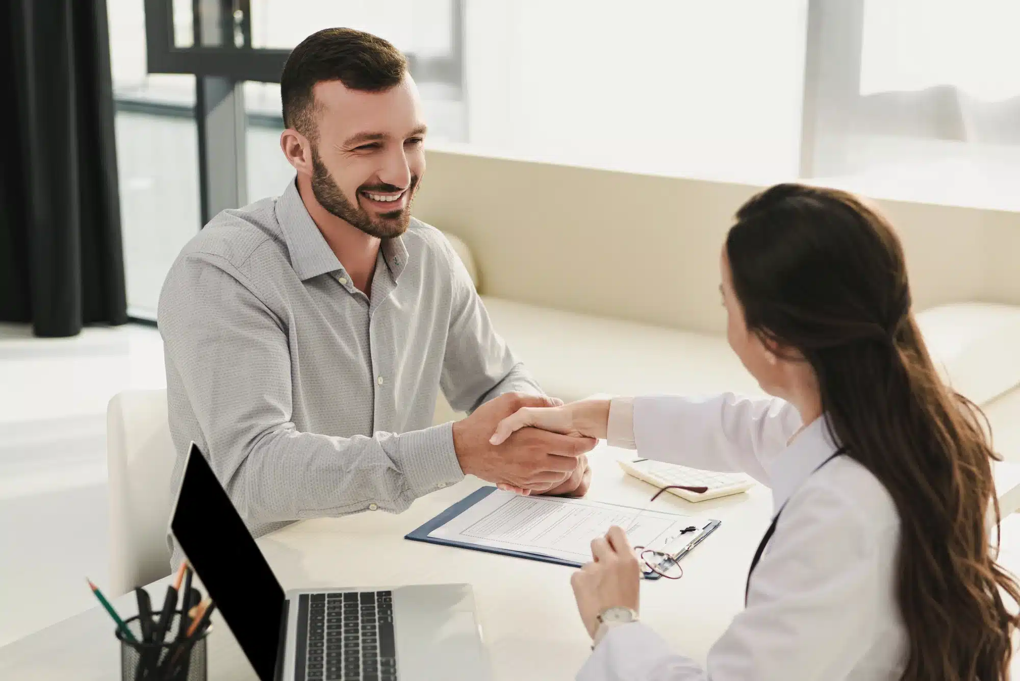 Medical professional shaking hands with client