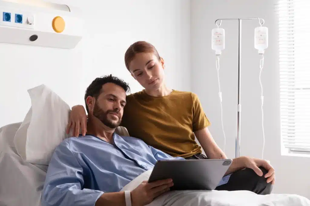 Man receiving IV therapy at medspa, with girlfriend by his side