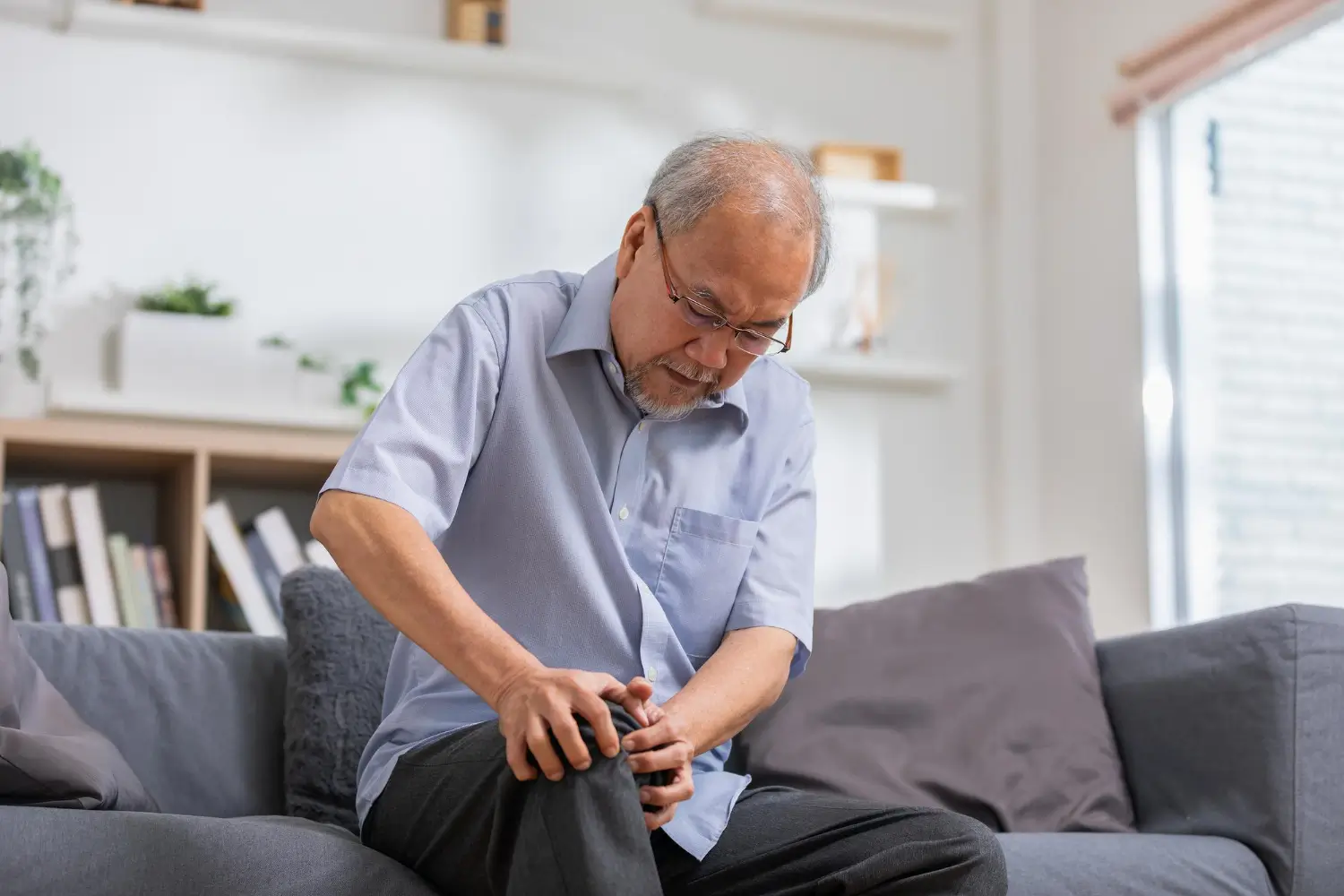 a senior male suffering from knee pain