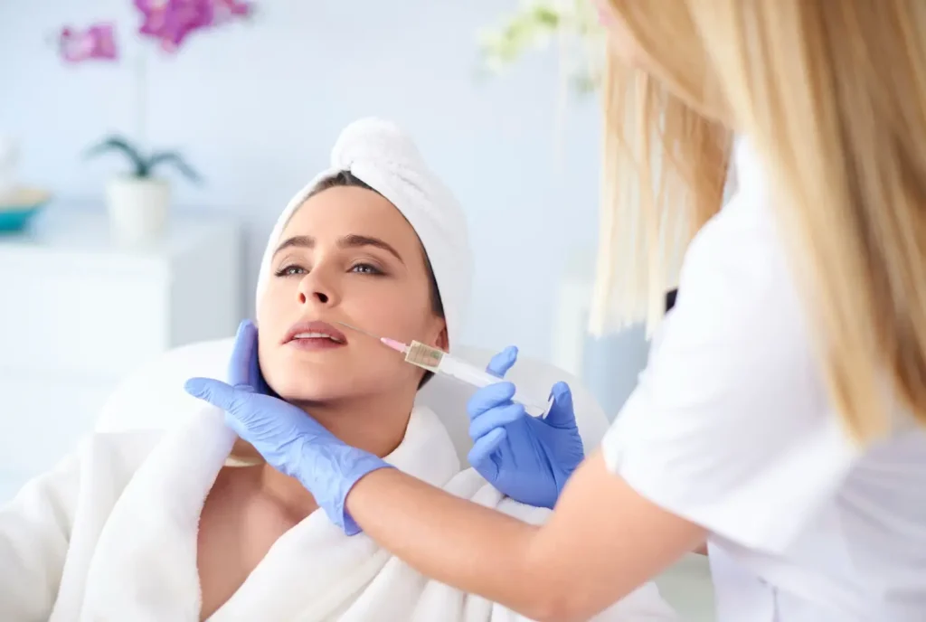 doctor injects on the woman's cheek