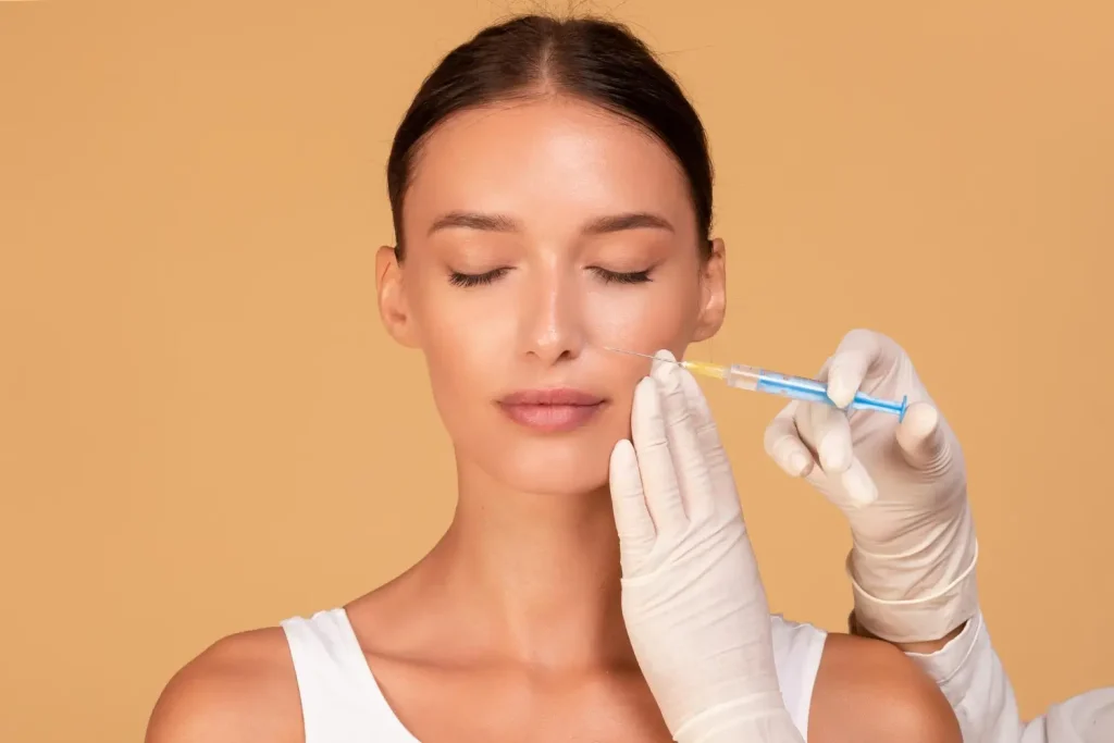 A professional carefully and skillfully injects filler for facial rejuvenation