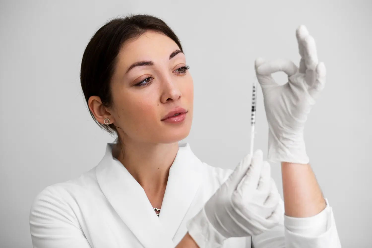 A healthcare professional prepares the injection before treatment