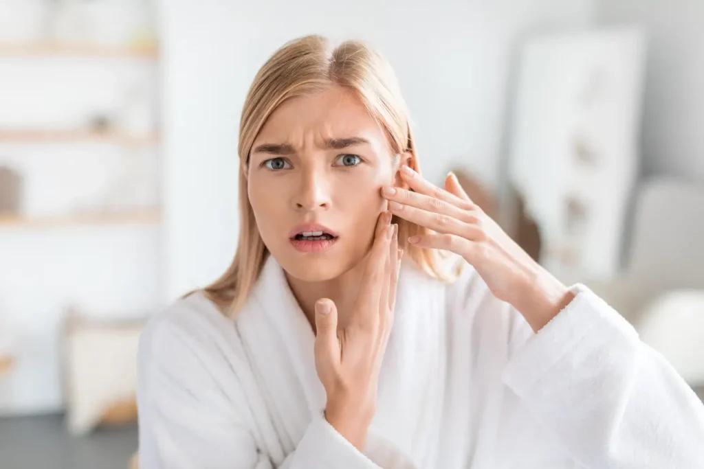 woman in shock seeing the swelling in her cheeks