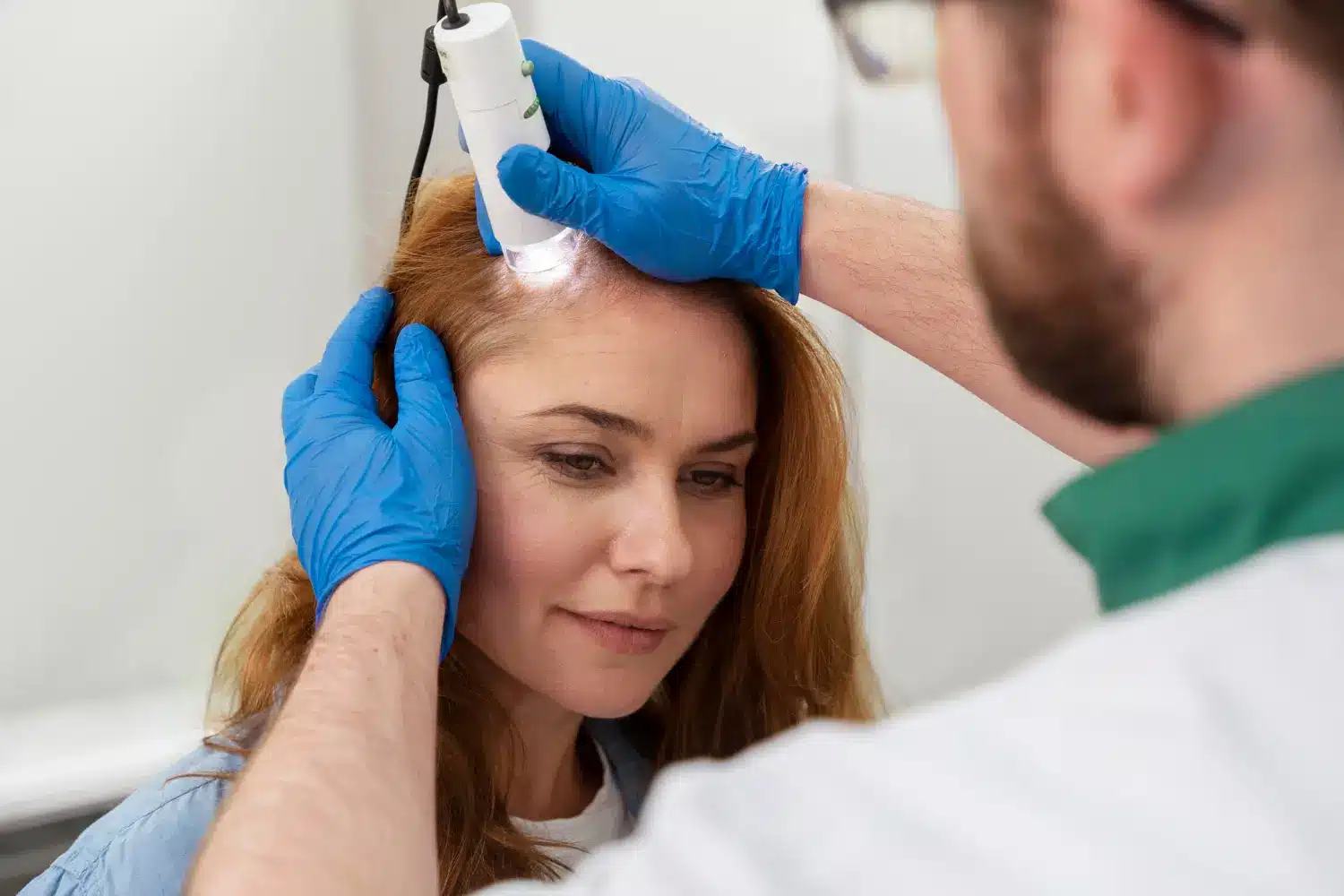 checking the scalp for hair growth treatment