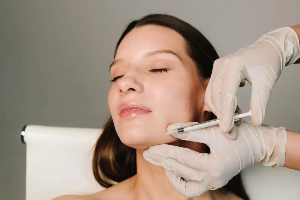 woman getting injection in her chin for rejuvenation