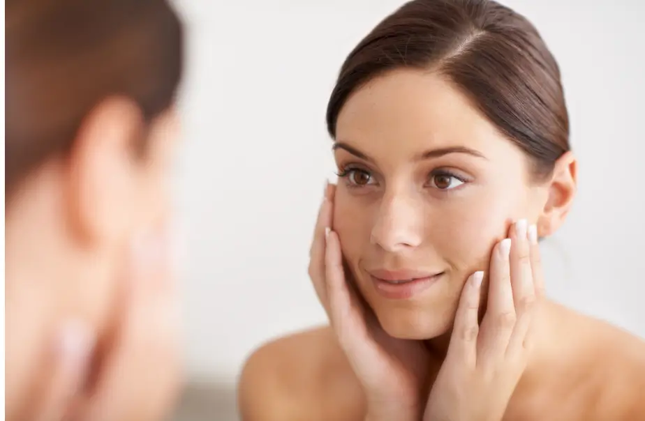 patient looks at herself in the mirror and smiles