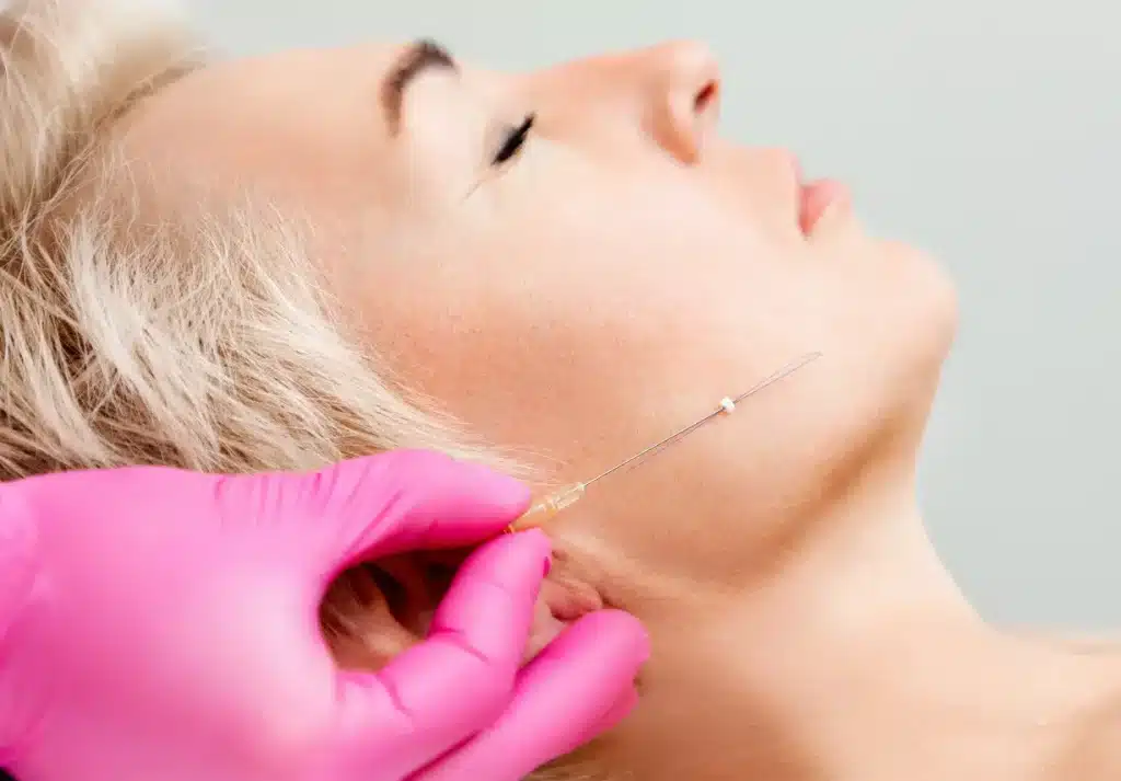 doctor showing the threading needle before the operation