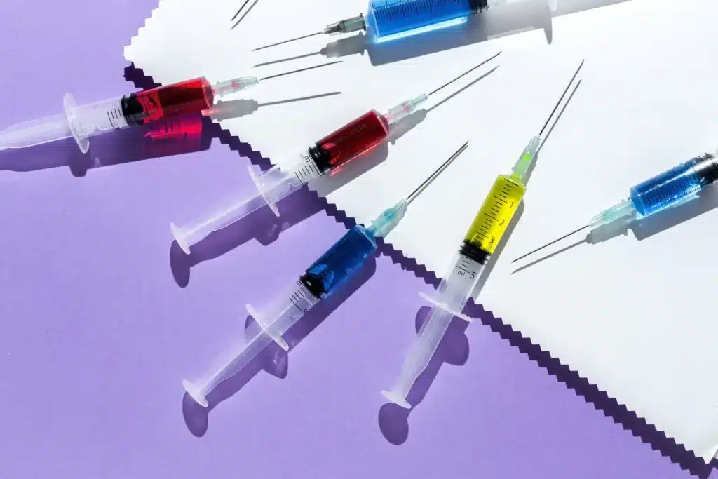 table with colorful syringes for injection